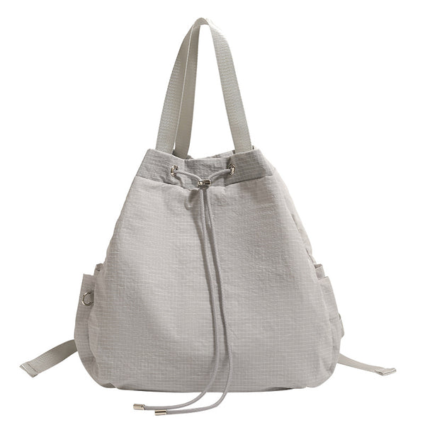 Large glacier gray grid-texture nylon drawstring backpack tote with dual top handles and adjustable backpack straps, detail