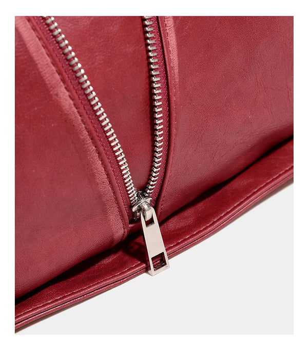 Slouchy hobo shoulder bag with wide braided eyelet strap, multiple front zip compartments, and silver-tone ring buckle