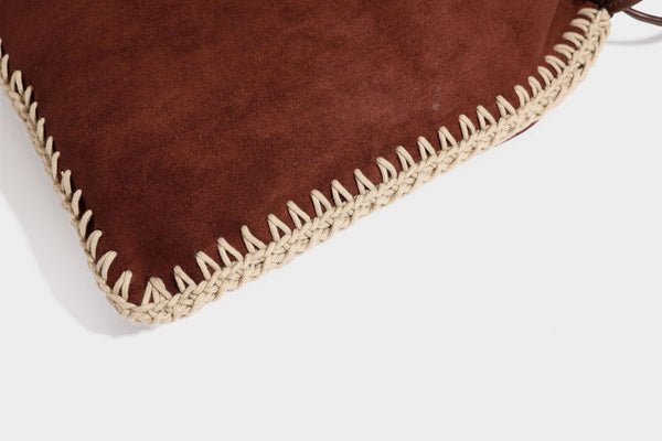 Matte suede-look drawstring bucket bag with cream braided woven edge trim and slim adjustable leather-look shoulder strap