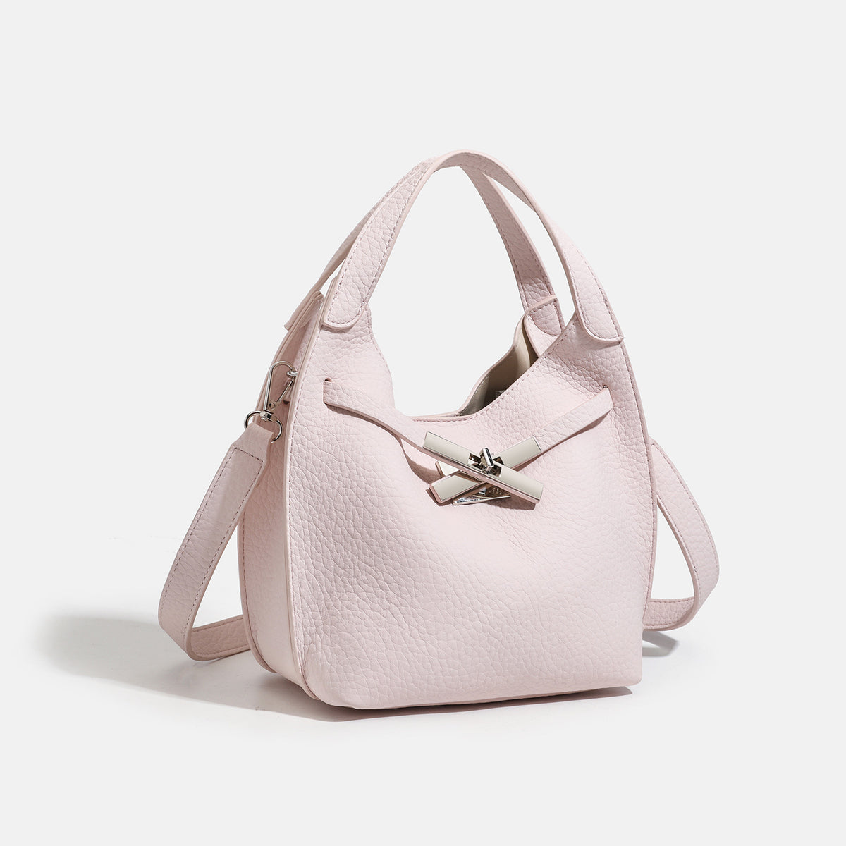 Compact pebbled leather-look shoulder bag with crossed silver-toned metal front closure, short top handle, and long, detail