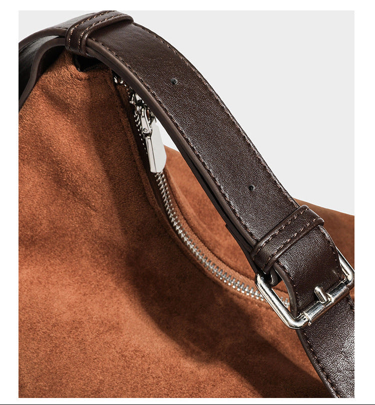 Cognac brown suede-look slouchy shoulder bag with dark brown leather-look trim, top zip closure, exterior side pocket, and