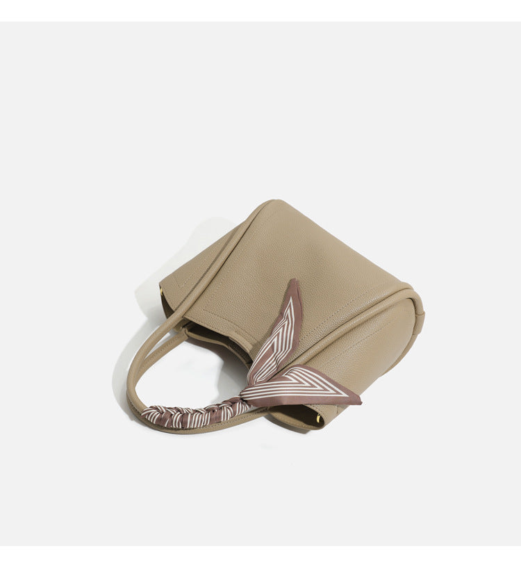 Pebbled leather-look bucket tote bag with scarf-wrapped top handle and gold-tone hardware, detail view 16