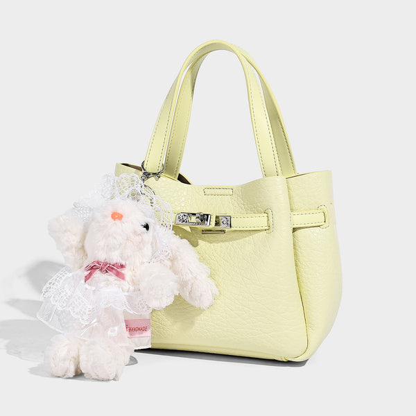 Small structured pebbled bucket tote with double top handles, silver turn-lock hardware, and detachable shoulder strap