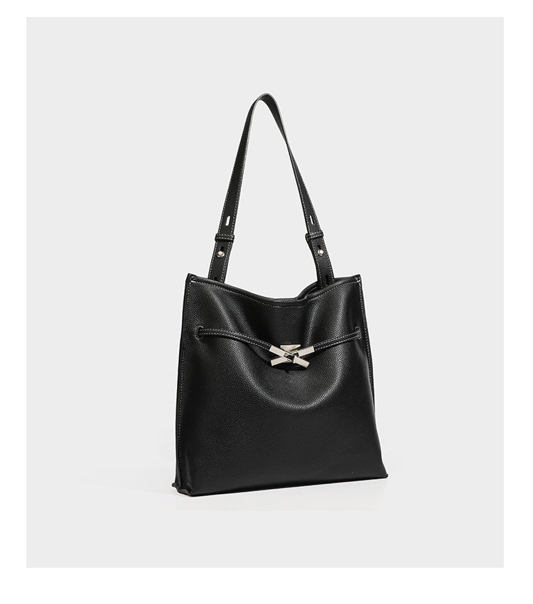 Large structured tote bag in pebbled leather-look finish with silver-tone twist-knot front detail and adjustable shoulder