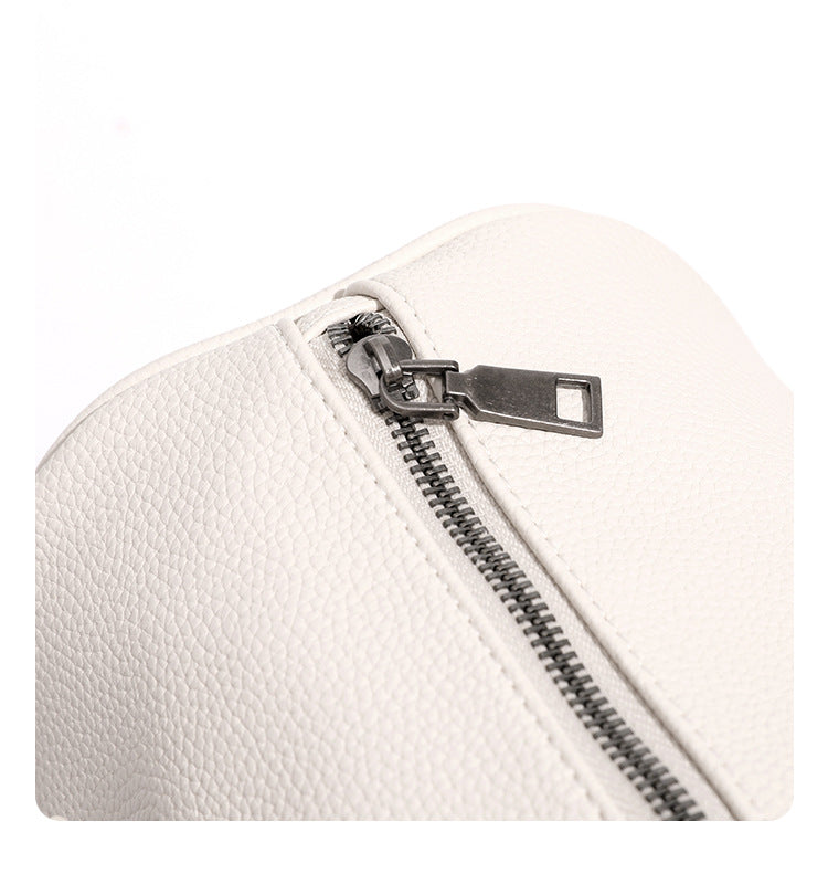 Large cream white pebbled leather-look barrel travel bag with twin top handles, chunky chain shoulder strap, front zip