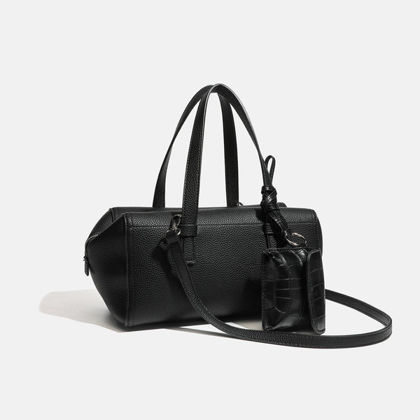 Structured pebbled leather-look top-zip barrel bag with dual handles, detachable shoulder strap, and attached croc-pattern