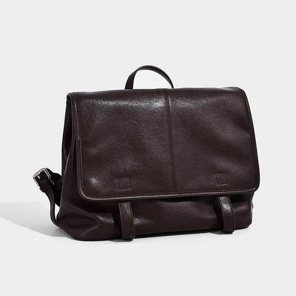Structured tan leather-look flap backpack handbag with top handle, silver buckle hardware, and fold-over front closure