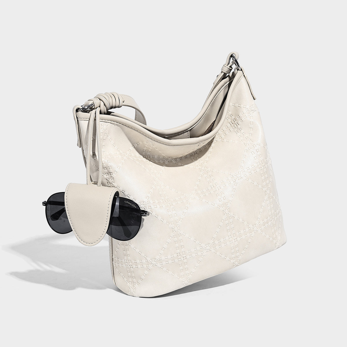 Diamond-quilted leather-look bucket shoulder bag with knotted strap accent and attached mini pouch, detail view 4