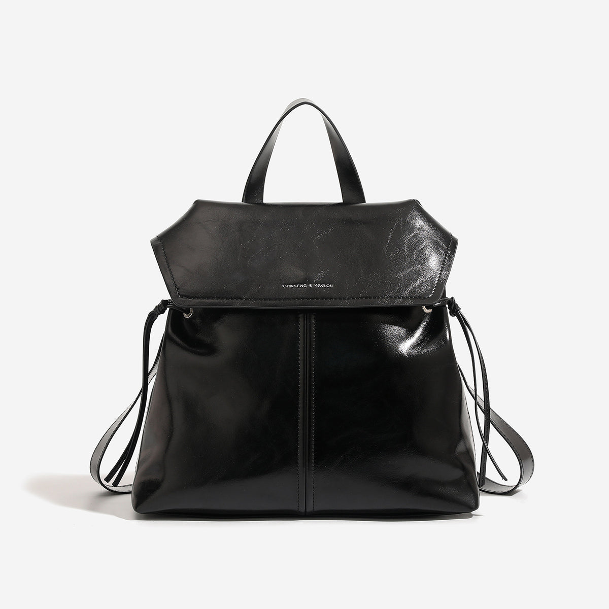 Structured flap-top backpack handbag in distressed leather-look finish with side drawstring ties and silver hardware, detail