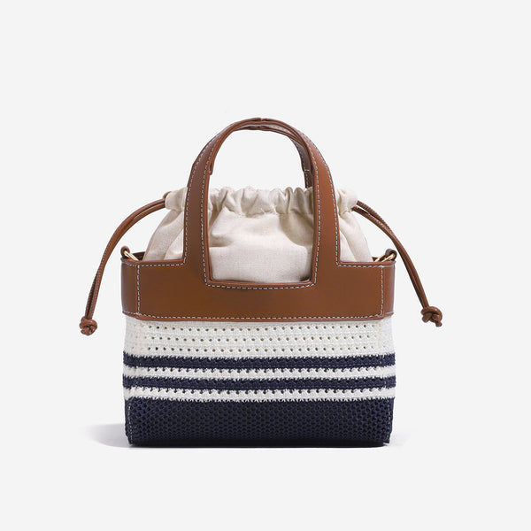 Small woven open-weave bucket bag with brown leather-look trim, cream gathered drawstring lining, dual top handles, and