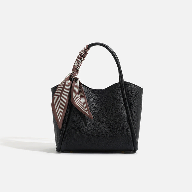 Pebbled leather-look bucket tote bag with scarf-wrapped top handle and gold-tone hardware, detail view 7