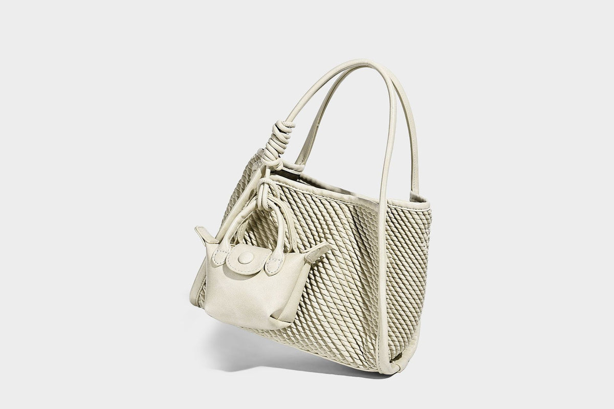 Large structured woven rope-texture tote bag with smooth leather-look trim, knotted dual top handles, detachable mini front