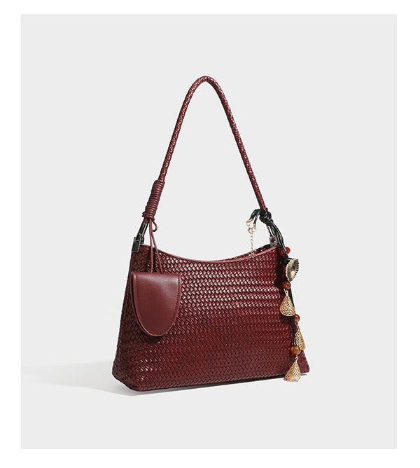 Woven-texture hobo shoulder bag in brown with braided top handle, adjustable crossbody strap, front flap pocket, and, detail