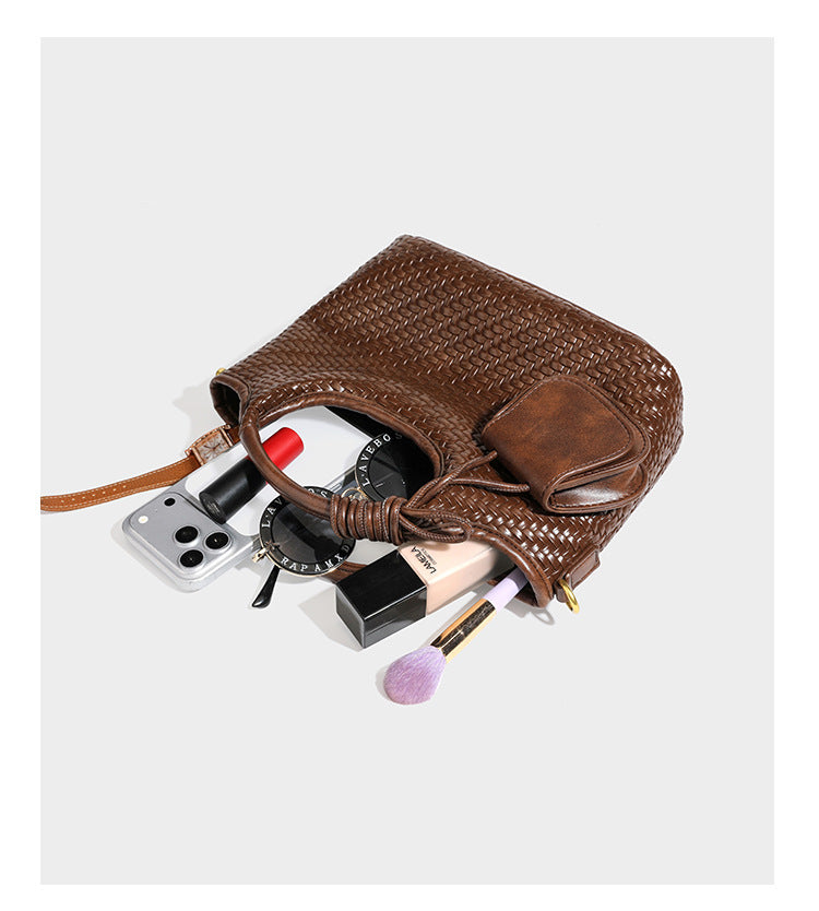 Woven leather-look tote bag in mocha brown with knotted top handle, front flap pocket, and detachable crossbody strap with