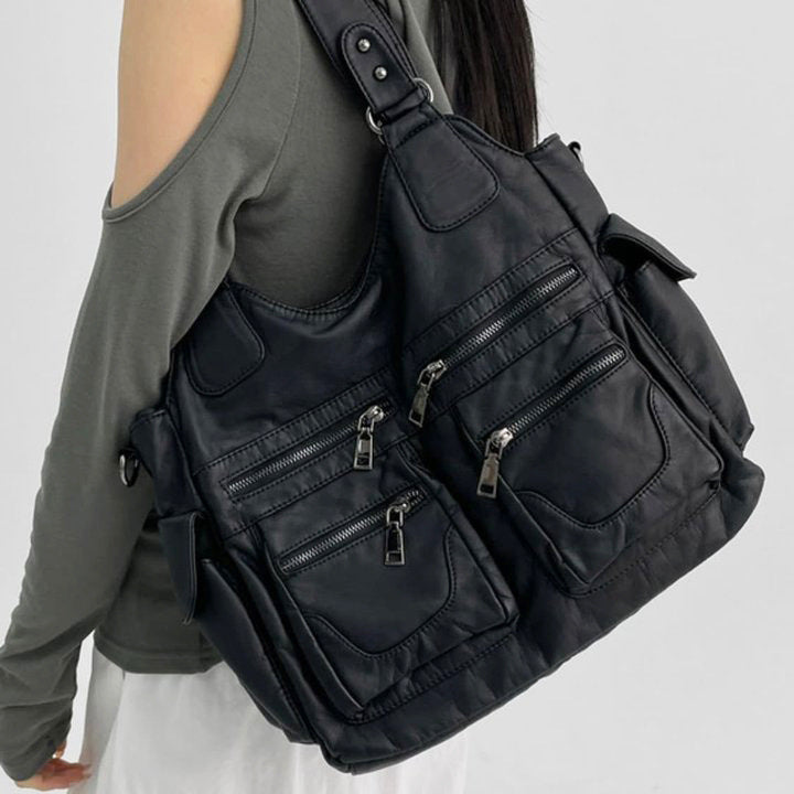 Large black distressed leather-look hobo shoulder bag with multi-zip front pockets, dual top handles, and removable