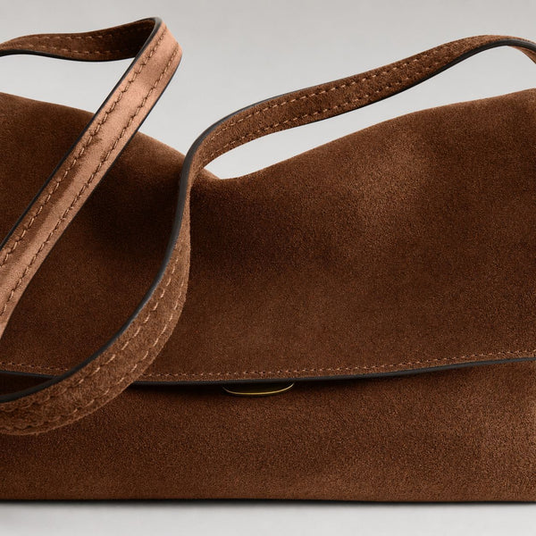 Rectangular matte suede-finish flap shoulder bag with slim dark strap and gold-tone turn-lock hardware, detail view 11