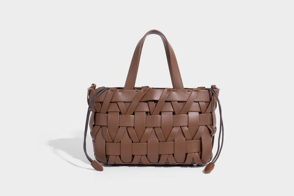 Structured woven basket tote handbag with contrasting dark trim, double top handles, detachable shoulder strap, and