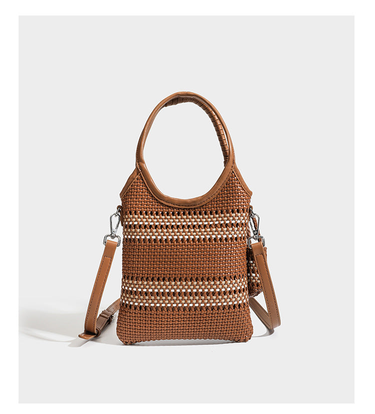 Color-block woven tote bag with rounded leather-look handles, detachable crossbody strap, and matching mini clip-on pouch in