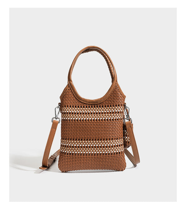 Color-block woven tote bag with rounded leather-look handles, detachable crossbody strap, and matching mini clip-on pouch in
