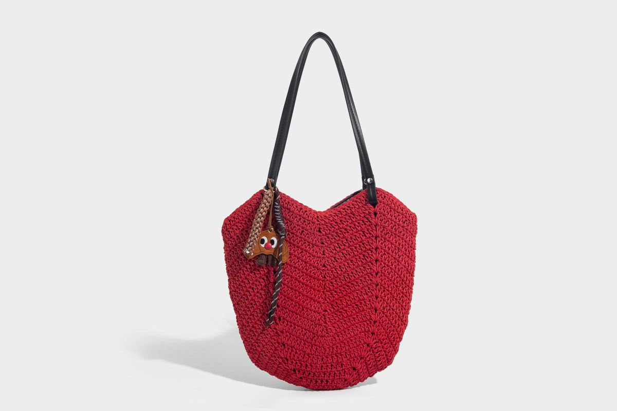 Woven crochet open-top shoulder tote bag with slim brown leather-look straps and braided charm accent, detail view 17
