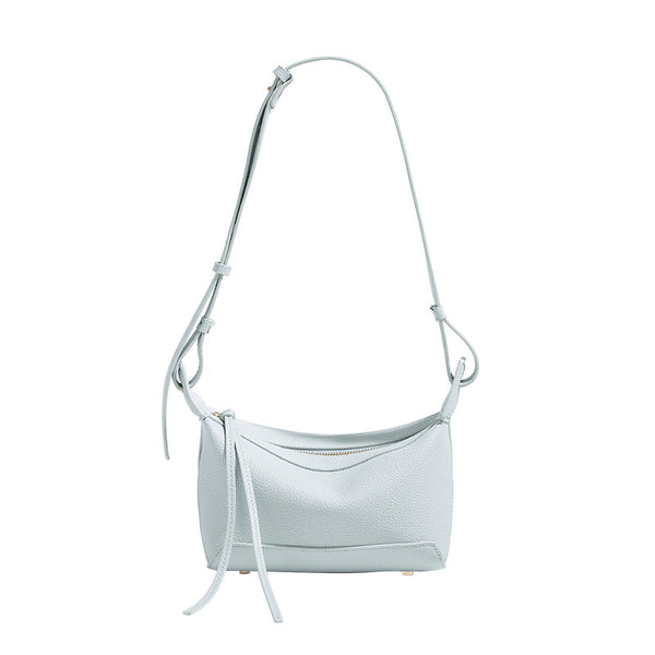 Small structured mini crossbody shoulder bag with pebbled texture, knotted adjustable strap, top zip closure, and gold-tone