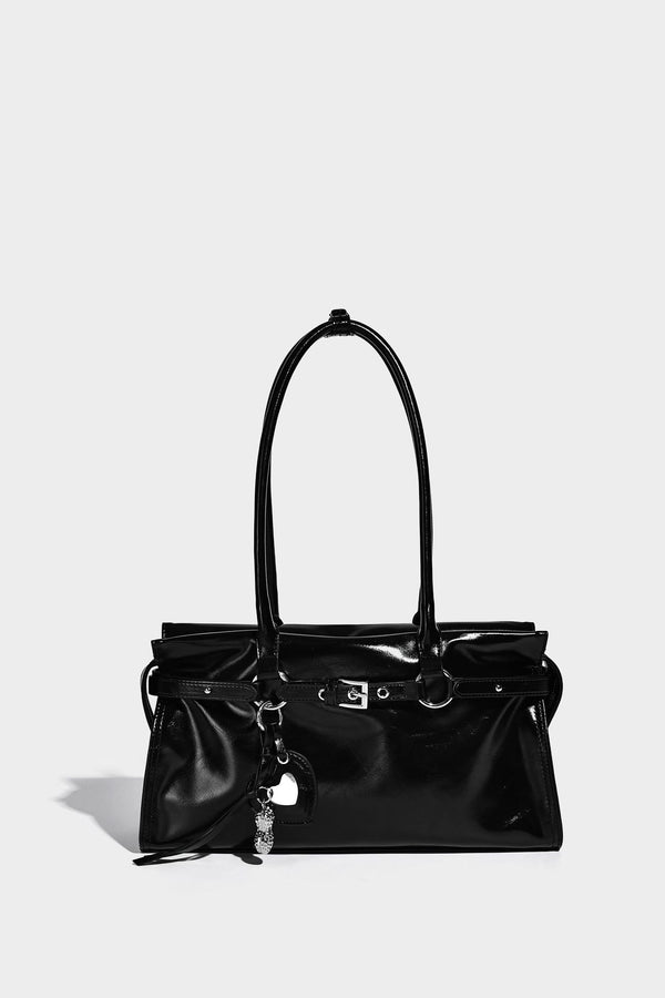 Structured rectangular glossy tote shoulder bag with belt buckle front strap and dangling charm hardware, detail view 23