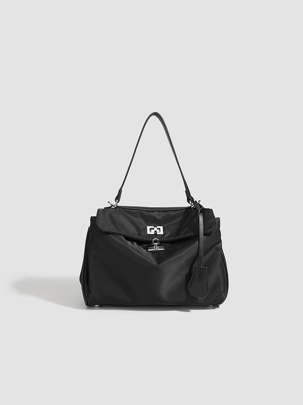 Structured black leather-look flap satchel bag with silver turn-lock hardware and top handle, detail view 10