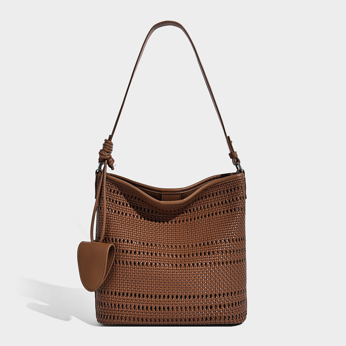 Handwoven open-weave shoulder bag with leather-look trim, knotted adjustable strap, and clip-on sunglasses sleeve pouch