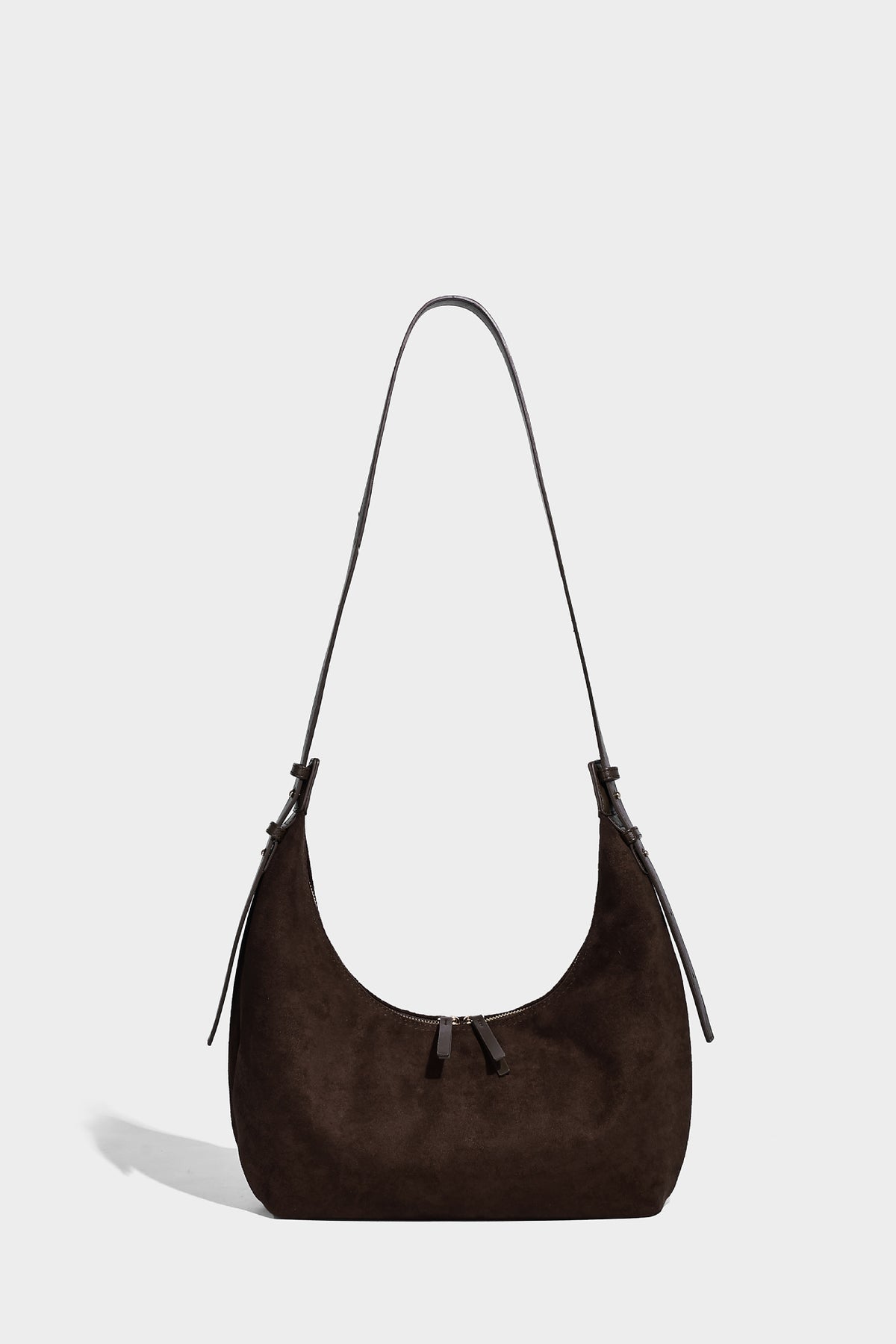 Slouchy crescent hobo shoulder bag in dark chocolate matte suede-look finish with adjustable strap and twin-pull top zip