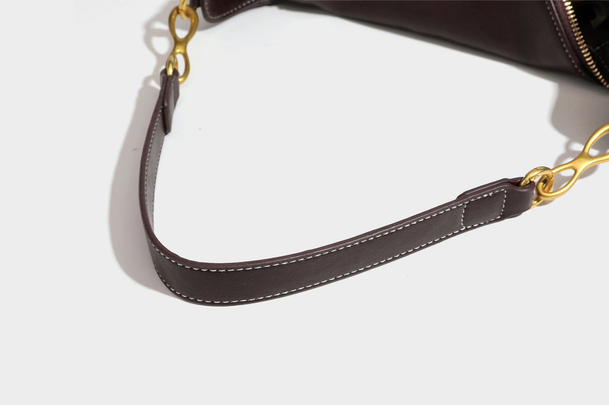 Lässige halbmondförmige Hobo-Schultertasche in Dunkelbraun mit goldfarbenem Ring und Kettenglied-Beschlägen sowie Reißverschluss oben, Detailansicht