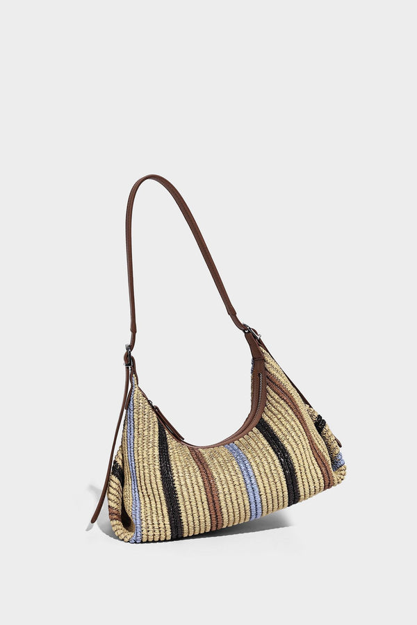 Slouchy woven straw hobo shoulder bag with beige, black, brown, and blue vertical stripes and brown leather-look trim, detail