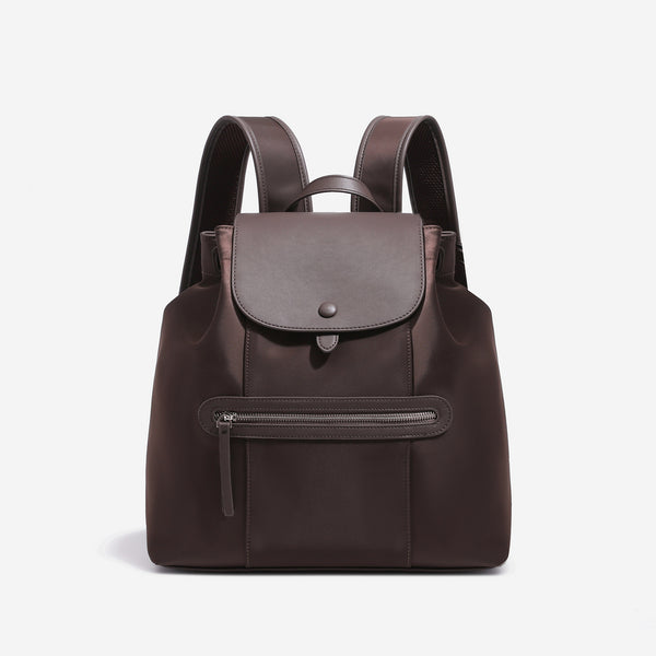 Large flap-top nylon backpack with leather-look trim, snap closure, front zip pocket, and padded shoulder straps, detail view