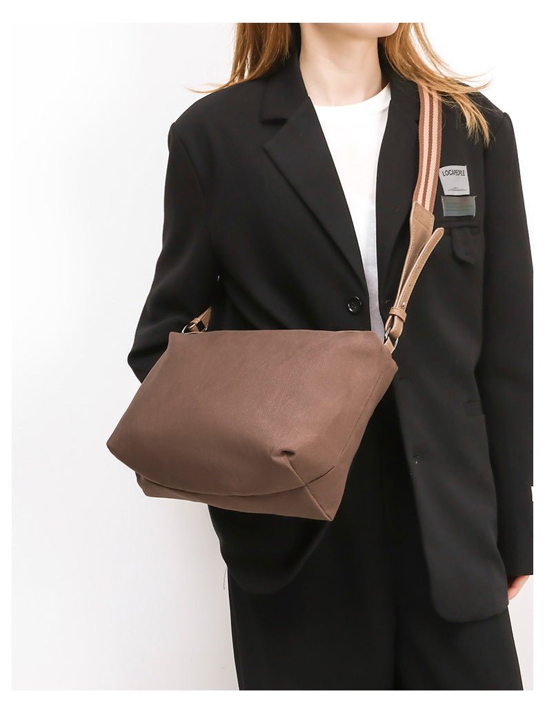 Retro structured matte leather-look tote bag in camel with front flap pocket, tassel pull, and double top handles, detail