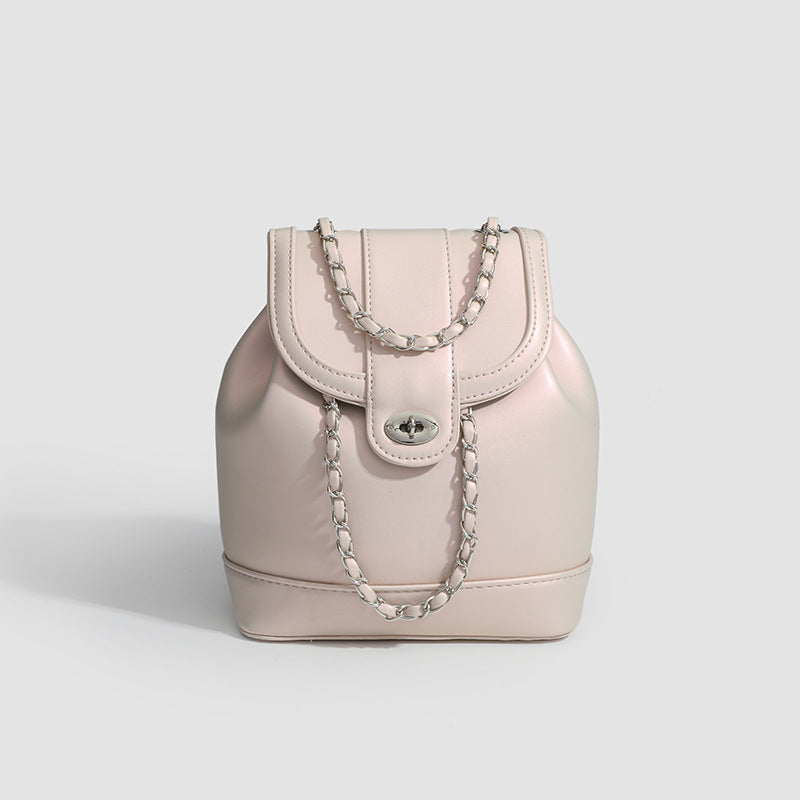 Small pearl-gloss backpack handbag with woven silver chain straps and turn-lock flap closure, detail view 6