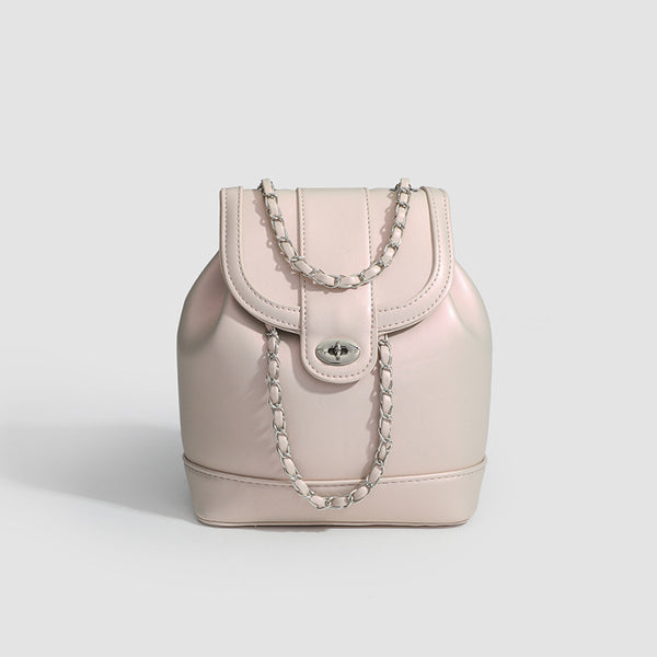 Small pearl-gloss backpack handbag with woven silver chain straps and turn-lock flap closure, detail view 6