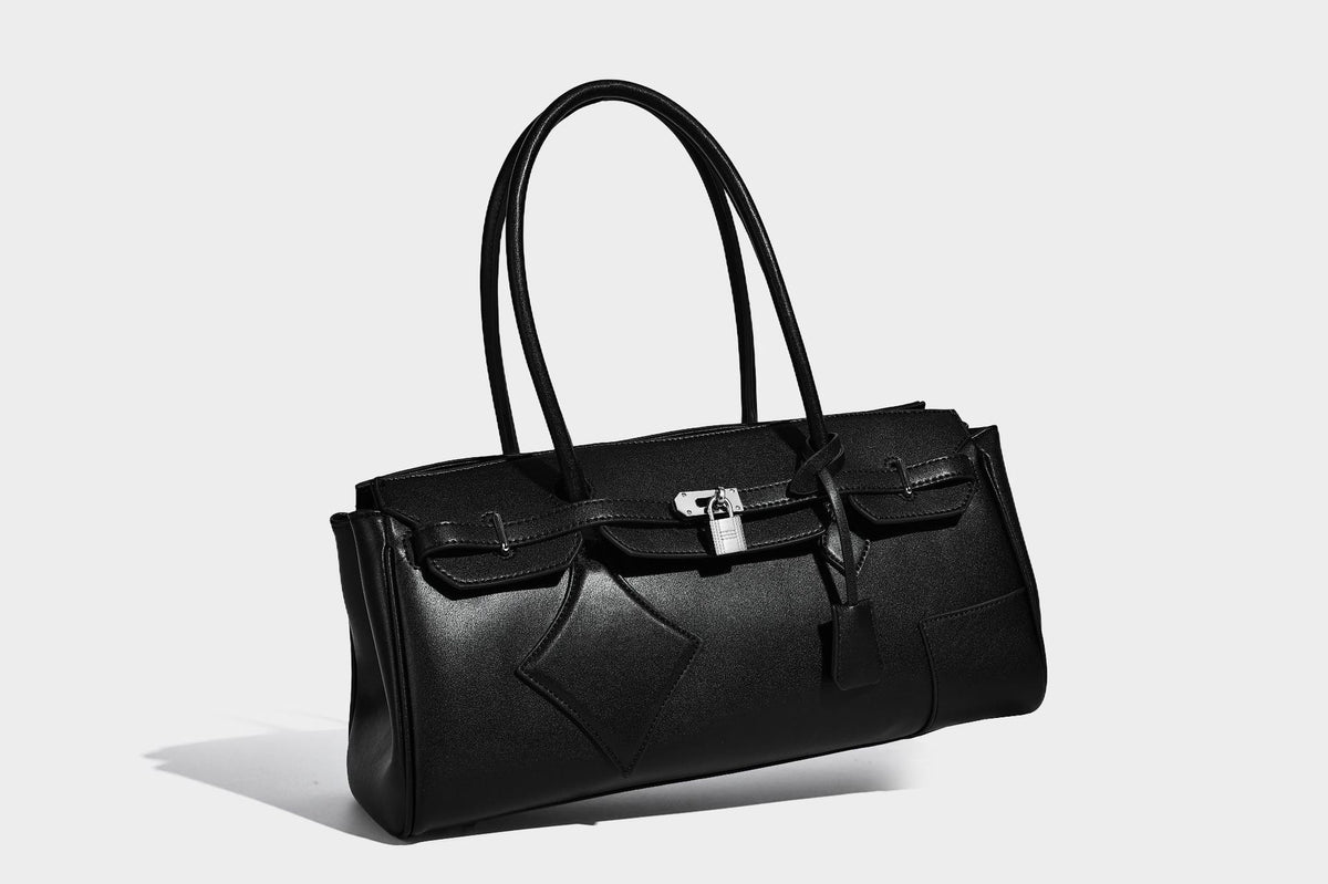 Strukturierte Tote-Bag in schwarzer Lederoptik mit Drehverschluss in Vorhängeschloss-Optik, dekorativen Riemendetails und abgerundeten Doppelhenkeln