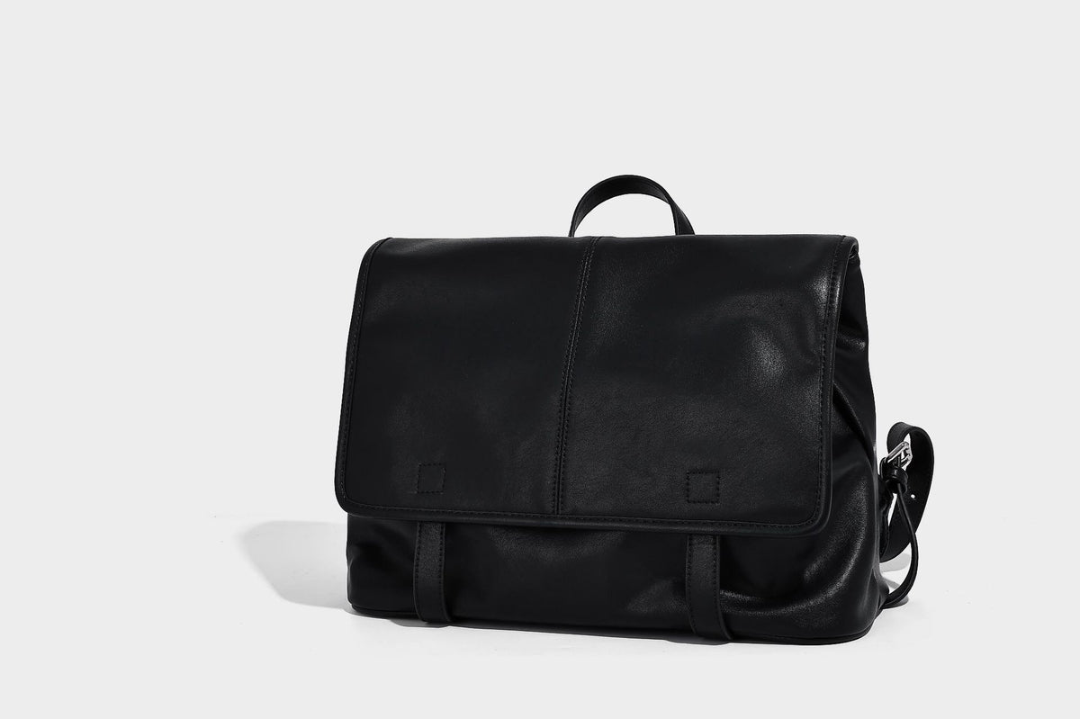 Structured tan leather-look flap backpack handbag with top handle, silver buckle hardware, and fold-over front closure
