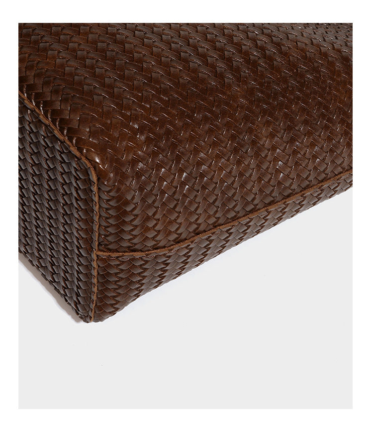 Large open-top woven leather-look tote bag in dark brown with scalloped edge, braided double shoulder straps, and decorative