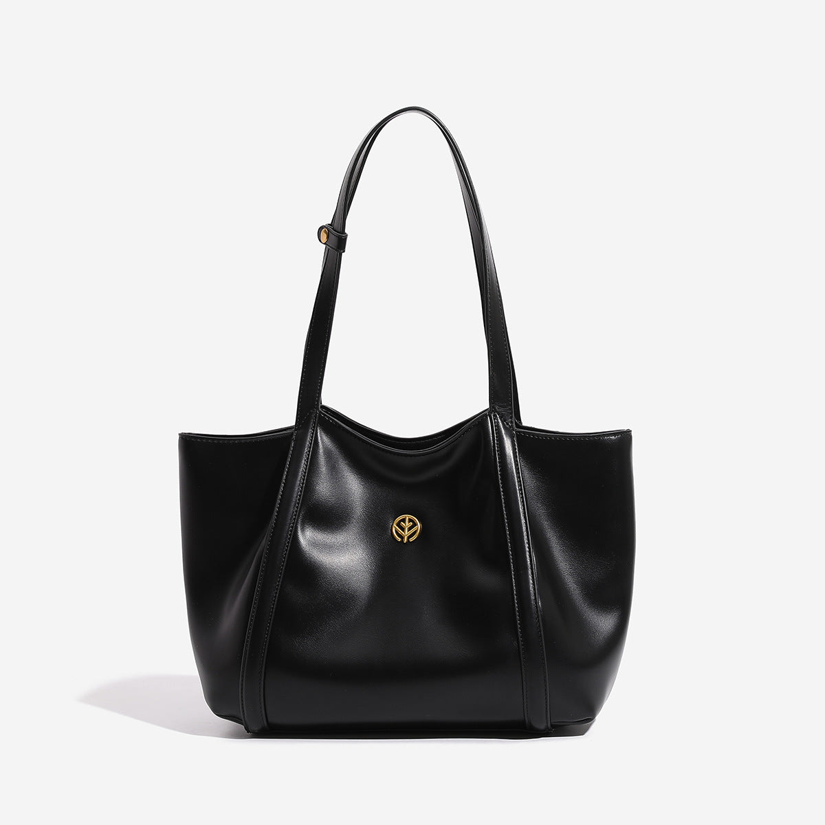 Structured open-top leather-look tote bag with long shoulder straps and gold-tone circular emblem hardware, detail view 6