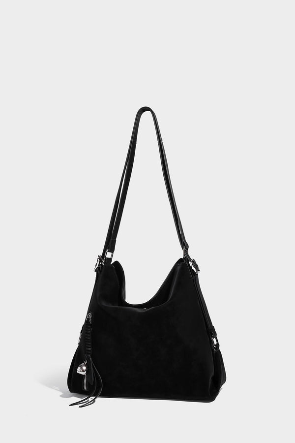 Slouchy hobo tote bag with matte leather-look finish, triangular silhouette, front zip pocket, and adjustable shoulder strap