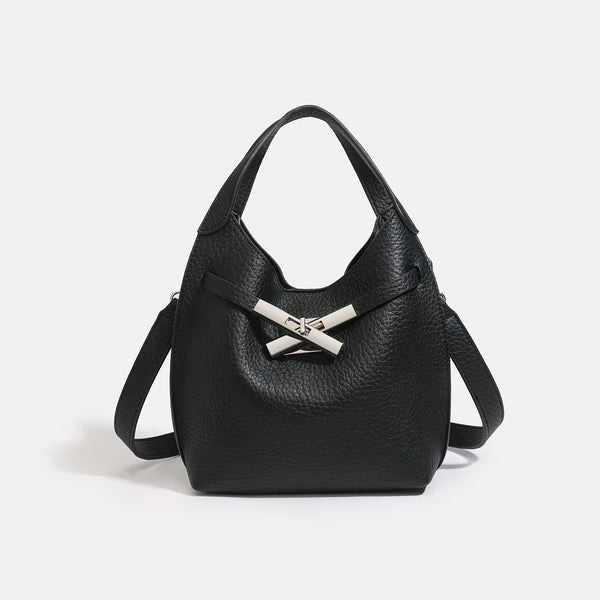 Compact pebbled leather-look shoulder bag with crossed silver-toned metal front closure, short top handle, and long, detail