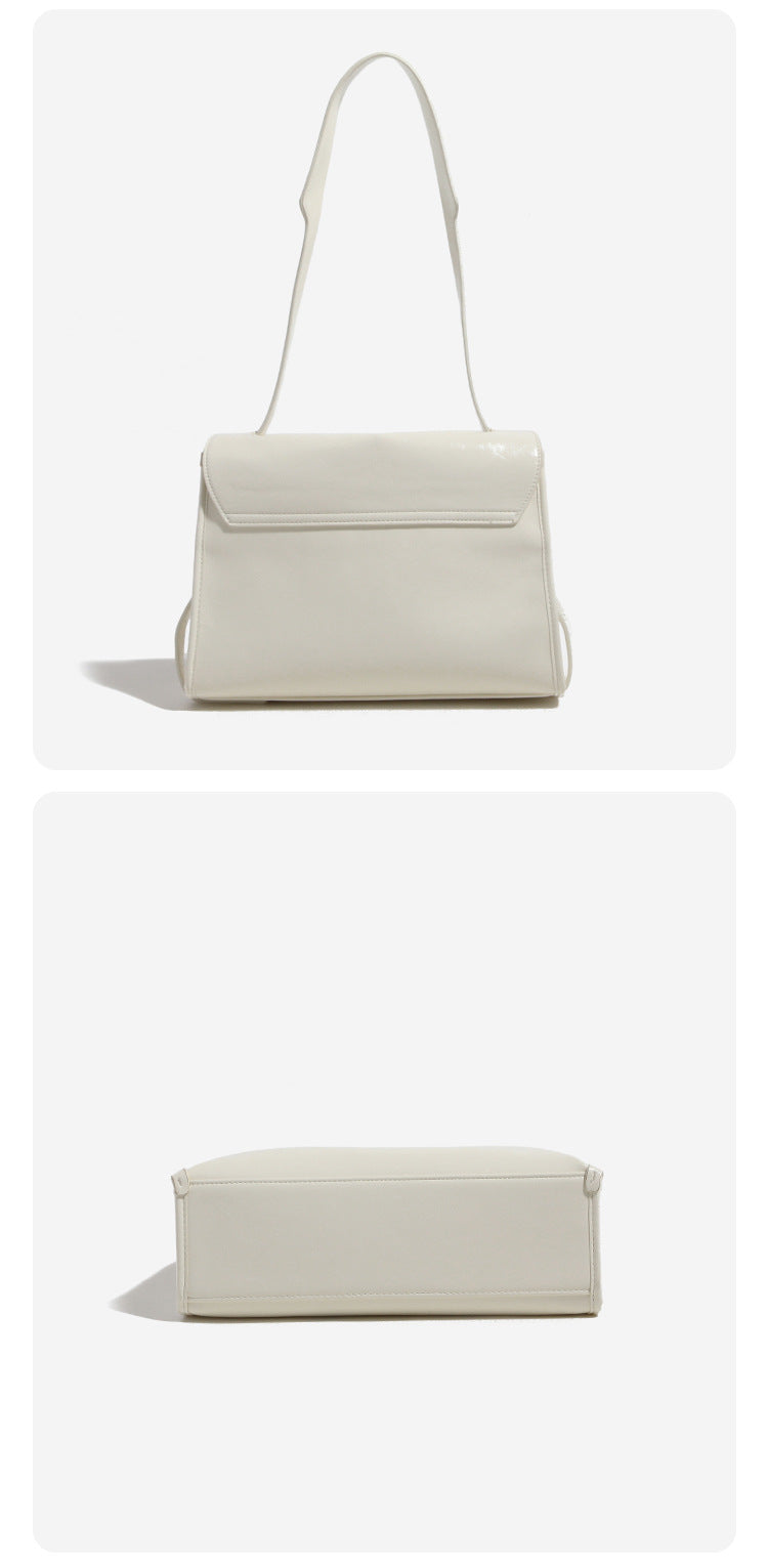 Structured rectangular flap shoulder bag in glossy leather-look finish with silver-tone turn-lock closure and adjustable