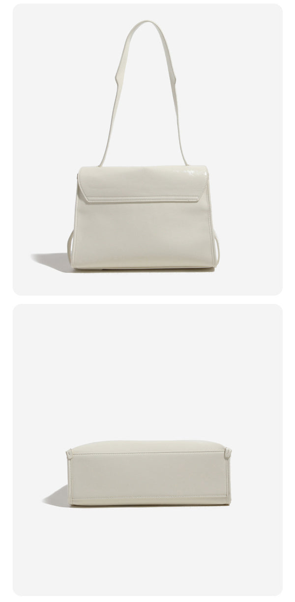 Structured rectangular flap shoulder bag in glossy leather-look finish with silver-tone turn-lock closure and adjustable