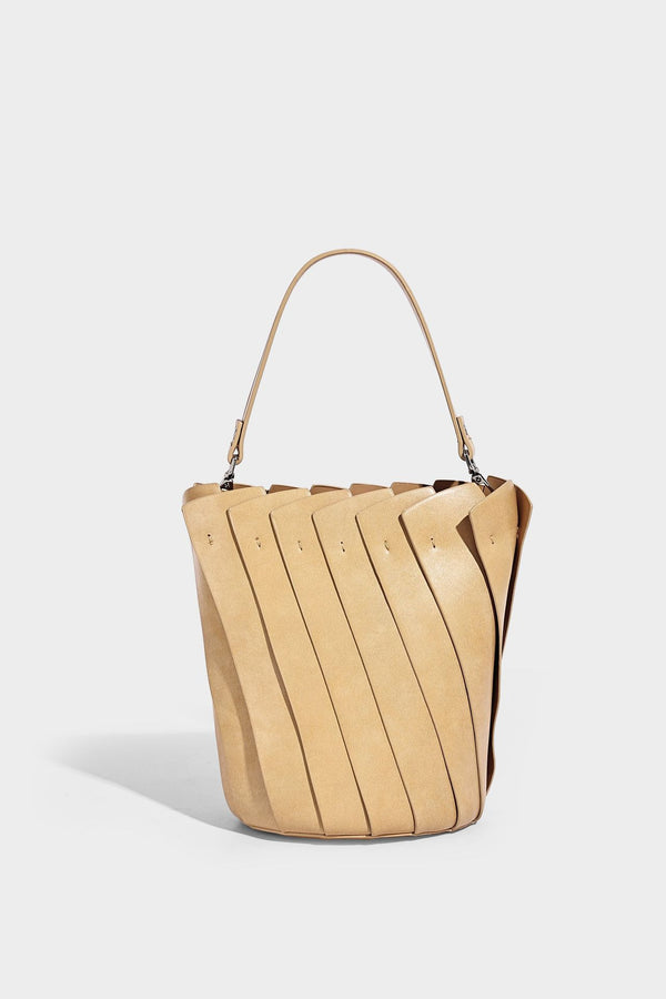 Structured pleated-panel bucket bag with curved top handle and detachable adjustable shoulder strap in smooth matte, detail