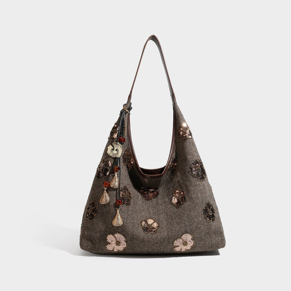 Lässige Trapez-Schulter-Tote in Anthrazit mit floralen Motiven aus silberfarbenen Pailletten, Trageriemen in Lederoptik und herabhängendem, perlenverziertem