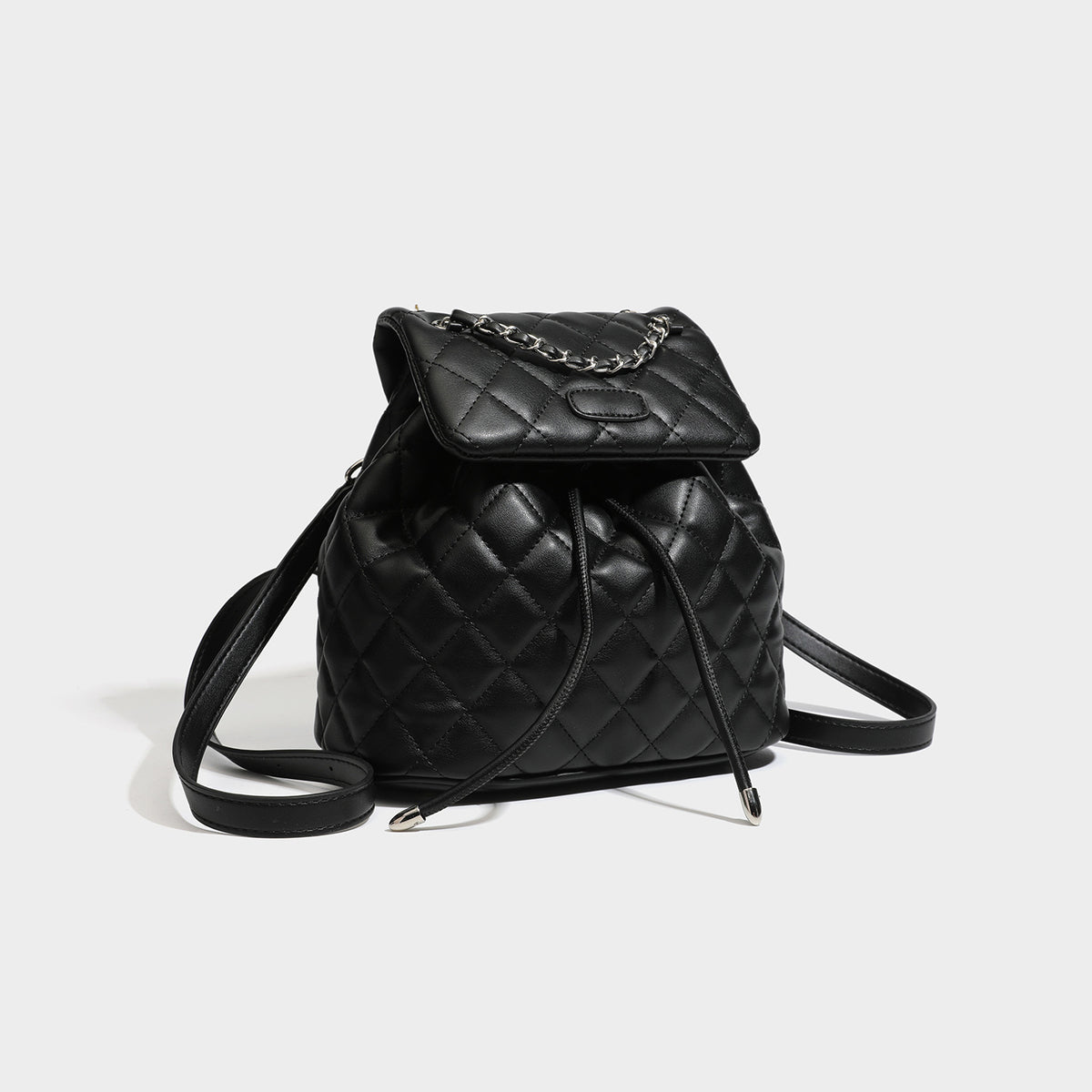 Black diamond-quilted backpack handbag with silver-tone chain flap accent and adjustable shoulder straps, detail view 3