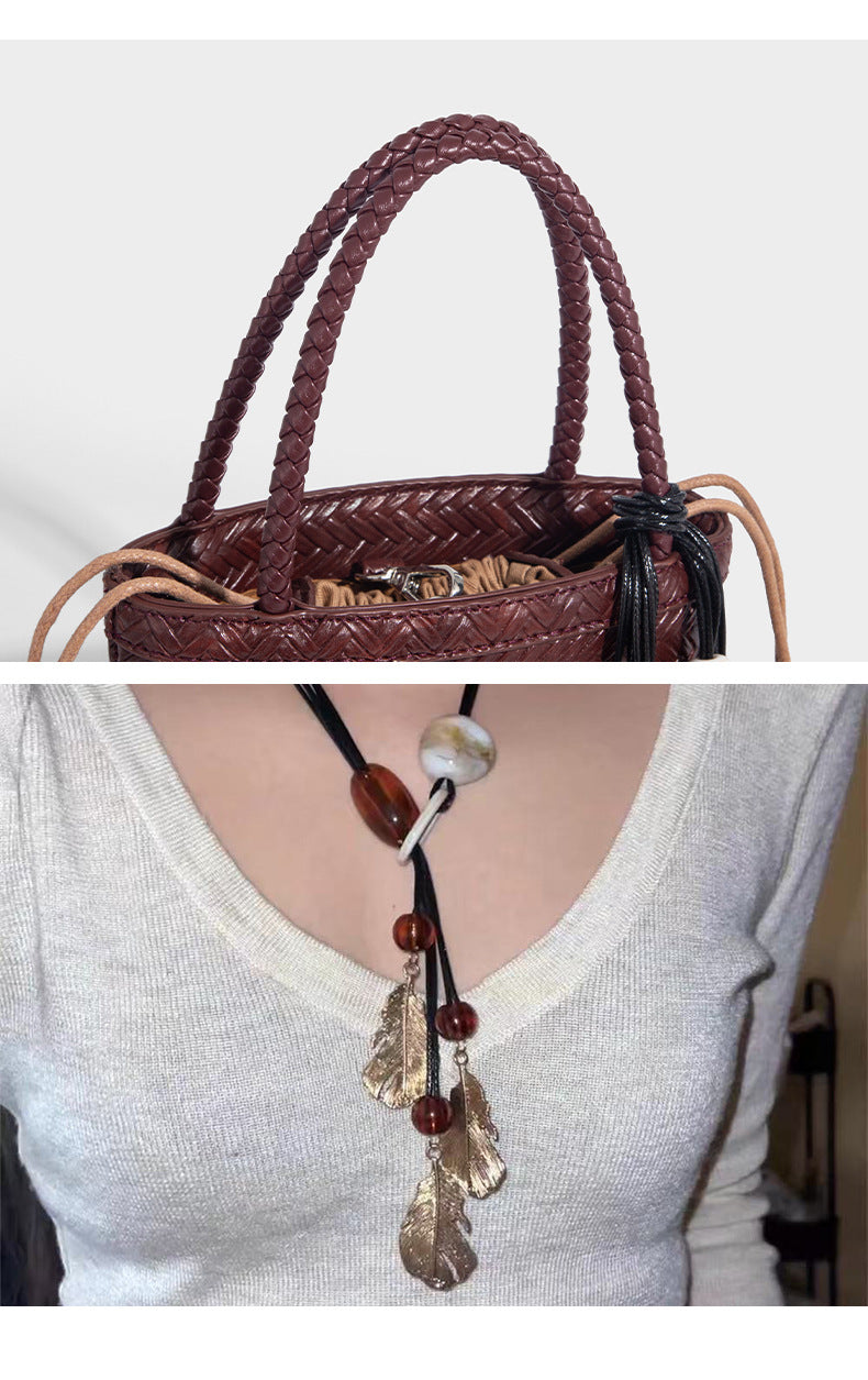 Small structured woven-texture tote bag with braided top handles and drawstring inner pouch, detail view 13