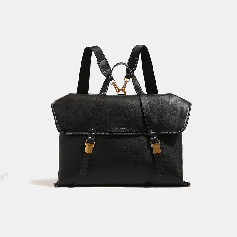 Strukturierter wandelbarer Rucksack im Denim-Look mit Besatz in Cognac-Lederoptik, goldfarbenen Schnallen und Tragegriff an der Oberseite