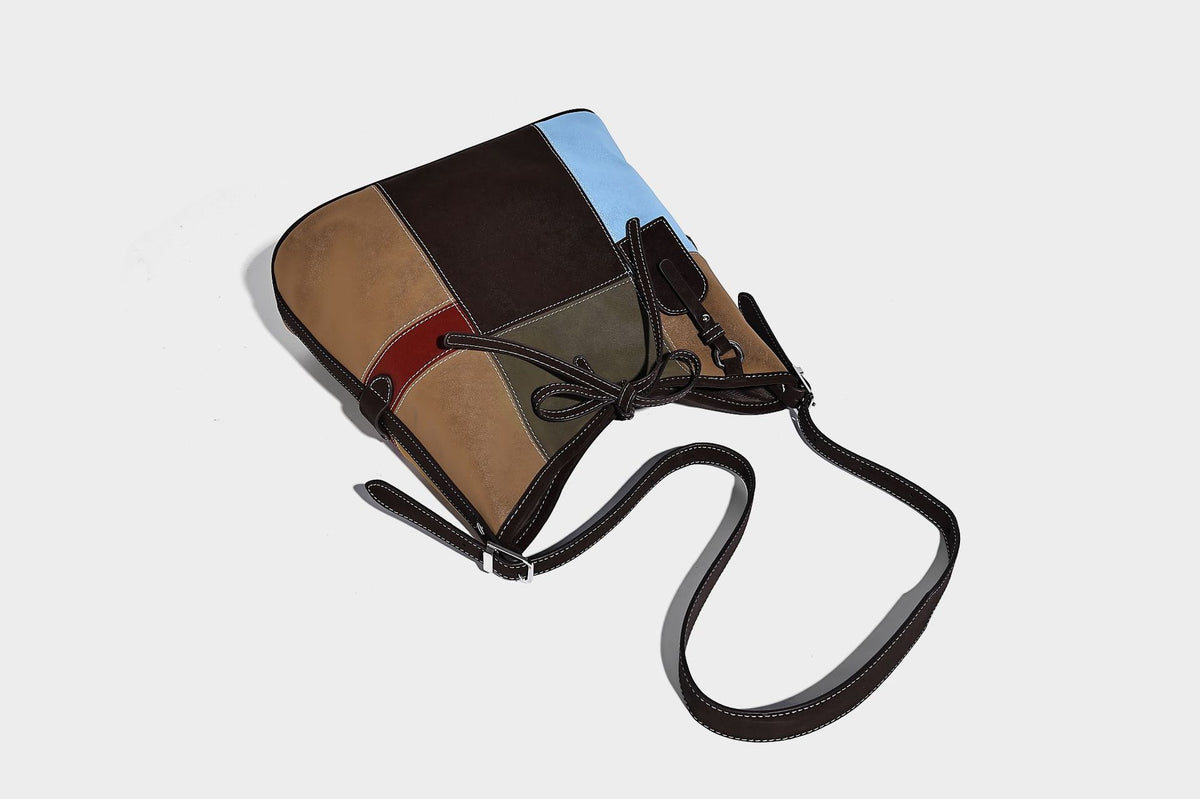 Patchwork bucket tote shoulder bag with tan, dark brown, olive, red, and sky blue color-block panels, white contrast, detail