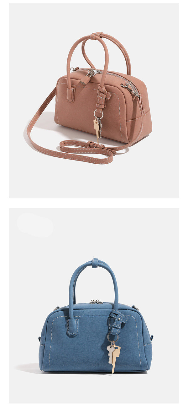 Compact retro Boston satchel bag with matte suede-look finish, twin rounded top handles, double zip closure with silver-tone